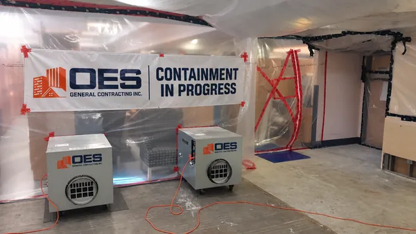 Air scrubbers and sealed plastic barriers in an occupied space