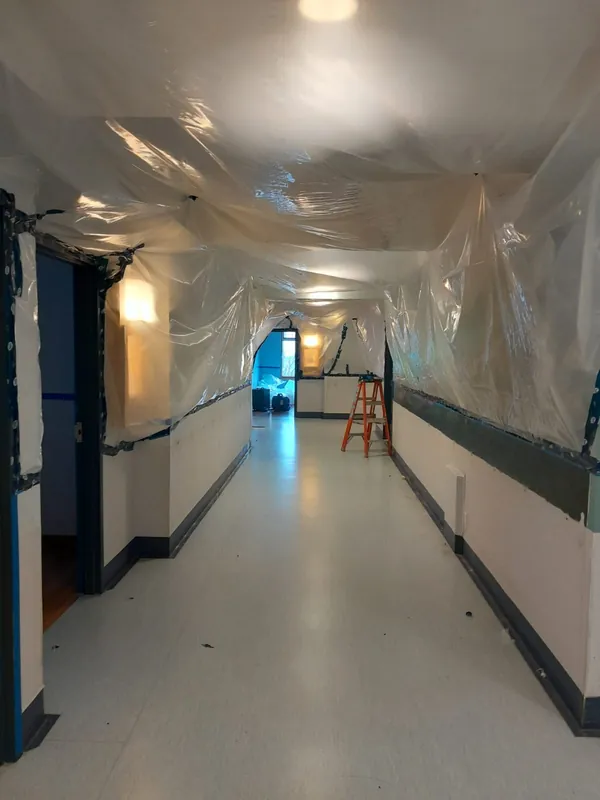 Corridor sealed with plastic sheeting during remediation