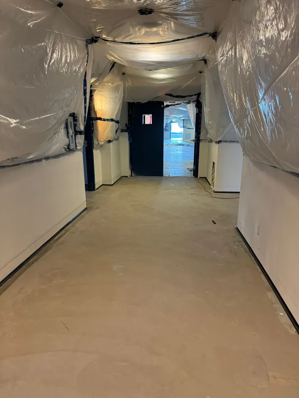 Corridor sealed with plastic sheeting during remediation