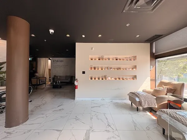 Entry and lounge with a marble floor at Knead Kitsilano
